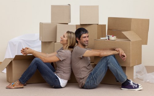 Man and van crew using protective equipment while moving furniture