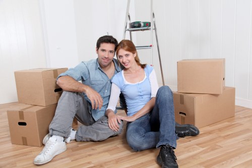 Removal workers loading furniture carefully during a home move in Hampstead